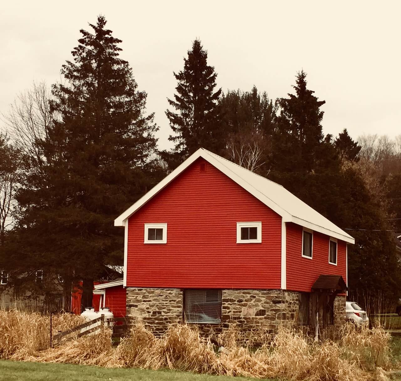 A countryside red house that is raised by 4 feet.